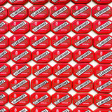 A repeating pattern of red octagonal Claridges London suitcases cookies on a white background.